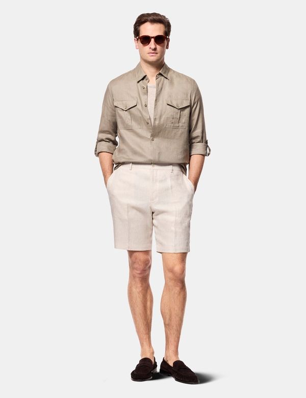 dress shirt with khaki shorts Today's summer outfit features a few classics that belong in any capsule wardrobe. A breathable linen shirt from Sand, timeless khaki shorts from Meyer, and a crisp white sneaker from Goodmanbecause some